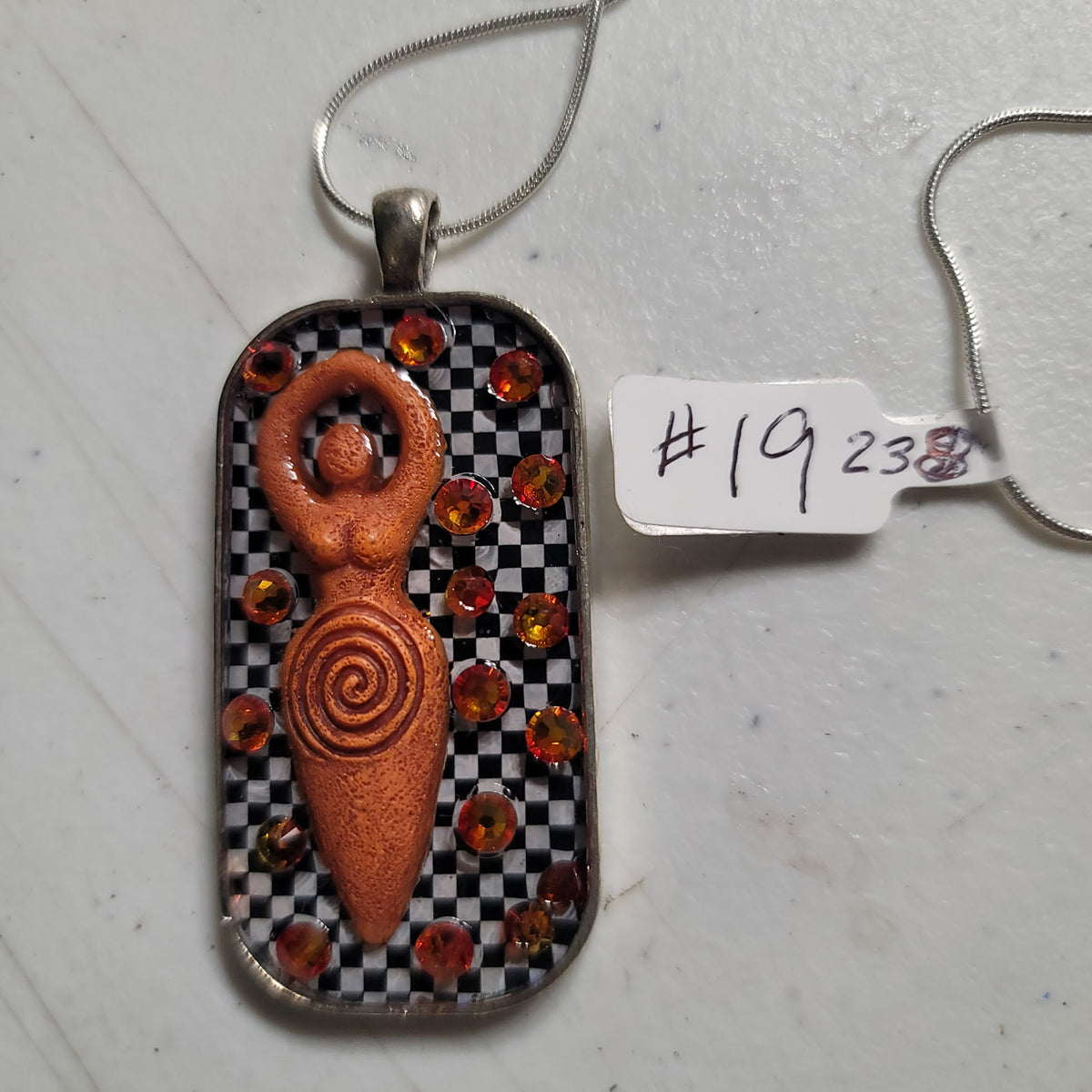 Goddess Pendant — Amber/Orange, Checkered Background