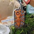 Goddess Pendant — Amber/Orange, Checkered Background