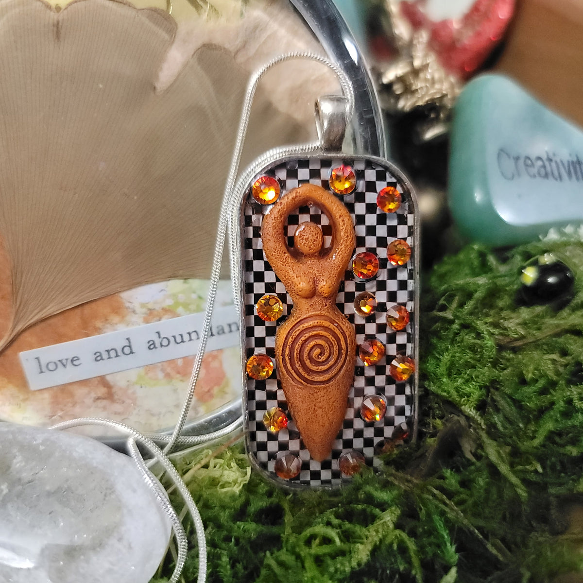 Goddess Pendant — Amber/Orange, Checkered Background